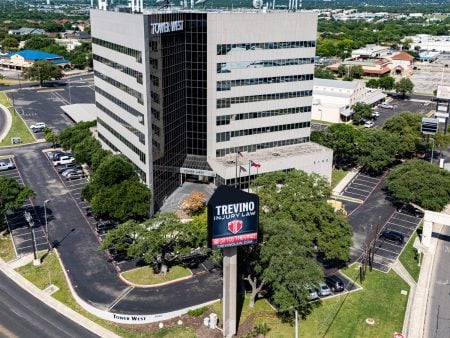 Best personal injury lawyer near me, San Antonio, TX. Aerial view of the modern Tower West office building, home to Trevino Injury Law with a red shield logo. Located at 6100 Bandera Rd #850, San Antonio, TX 78238. Trevino Injury Law in San Antonio is a trusted truck accident injury law firm with experienced personal injury trial Lawyers.