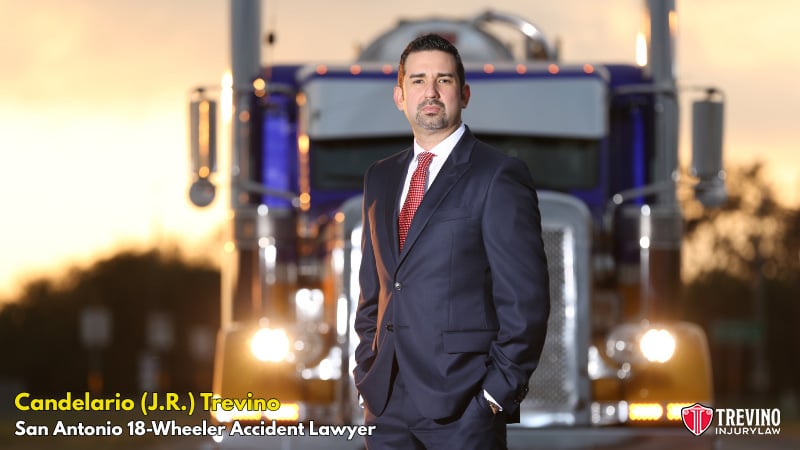 San Antonio 18-wheeler accident lawyer near me. 18-Wheeler accident lawyer Candelario (J.R.) Trevino, stands confidently in front of a large blue semi-truck at sunset. Text reads: "Candelario (J.R.) Trevino, San Antonio Truck Accident Lawyer" with the Trevino Injury Law logo in the bottom right corner.